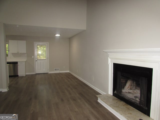 unfurnished living room with dark wood-type flooring