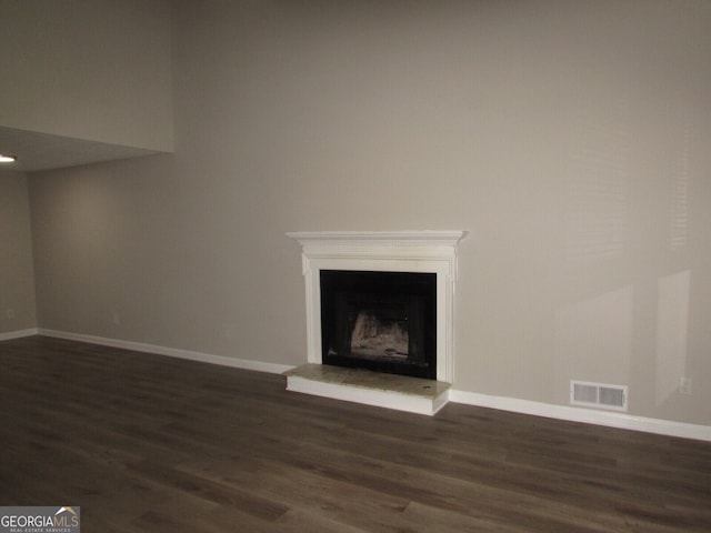 unfurnished living room with dark hardwood / wood-style flooring