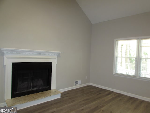 unfurnished living room featuring dark hardwood / wood-style flooring and vaulted ceiling