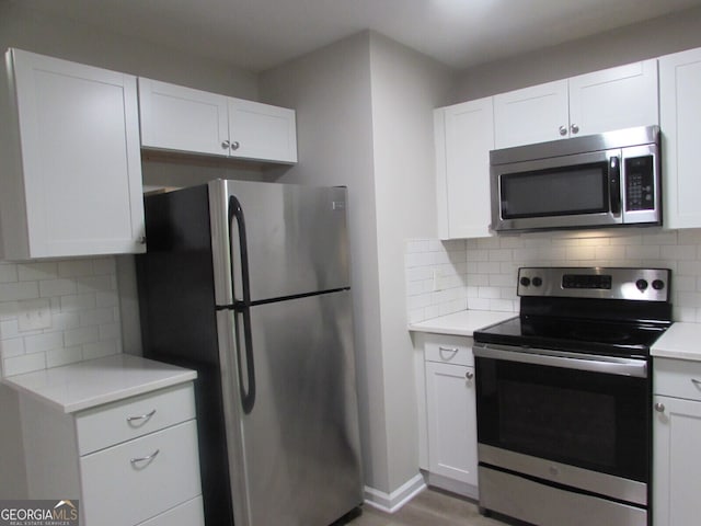 kitchen featuring white cabinetry, tasteful backsplash, and appliances with stainless steel finishes