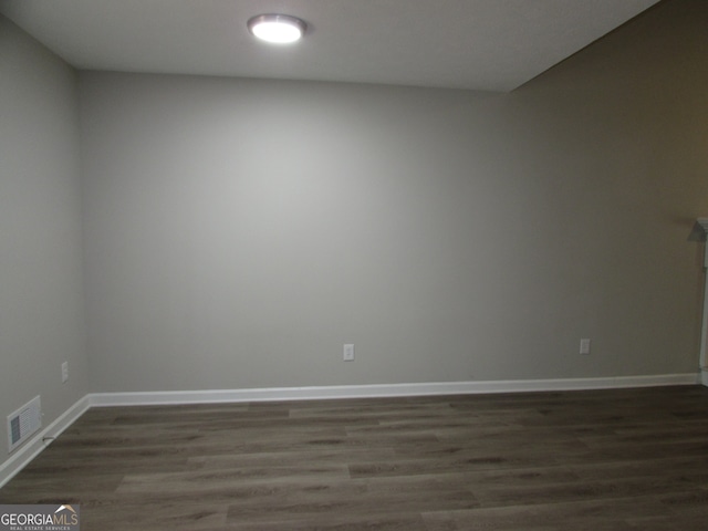 empty room with dark hardwood / wood-style floors