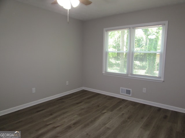 unfurnished room with ceiling fan and dark hardwood / wood-style floors