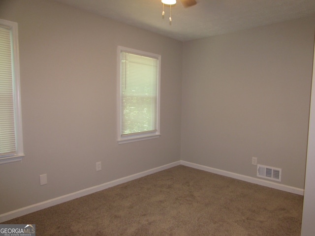 spare room featuring carpet floors and ceiling fan