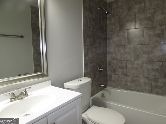 full bathroom featuring toilet, tiled shower / bath combo, and vanity