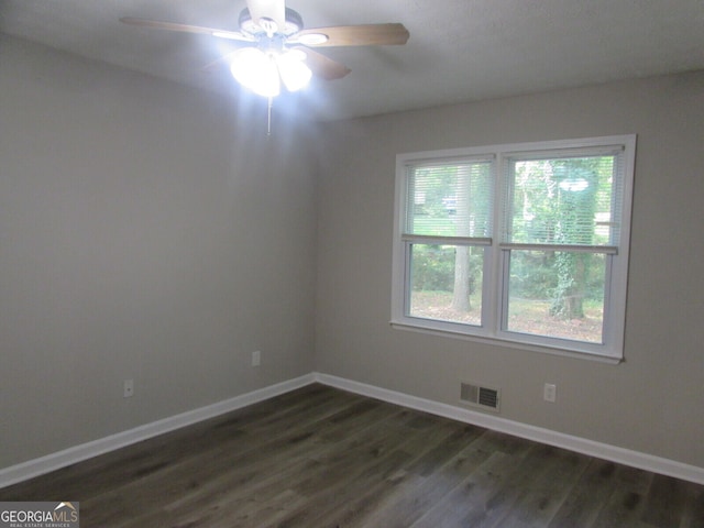 unfurnished room featuring dark hardwood / wood-style floors and ceiling fan