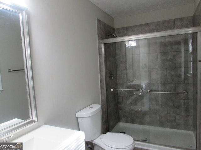 bathroom with toilet and walk in shower