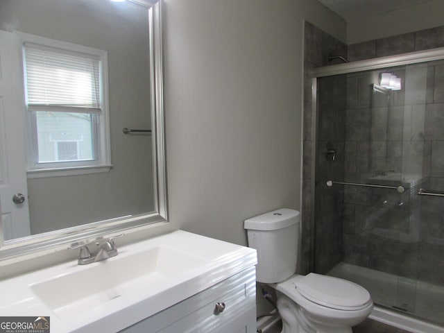 bathroom featuring vanity, toilet, and walk in shower