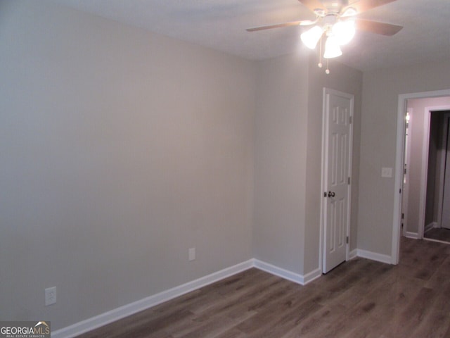 spare room featuring ceiling fan and dark hardwood / wood-style flooring