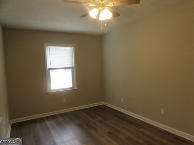 empty room featuring ceiling fan and dark hardwood / wood-style flooring