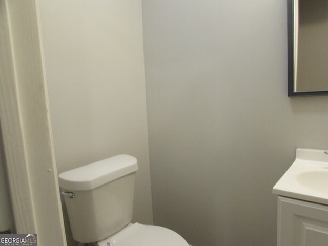 bathroom featuring vanity and toilet