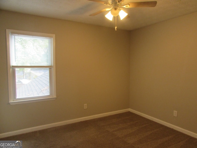 carpeted spare room featuring ceiling fan