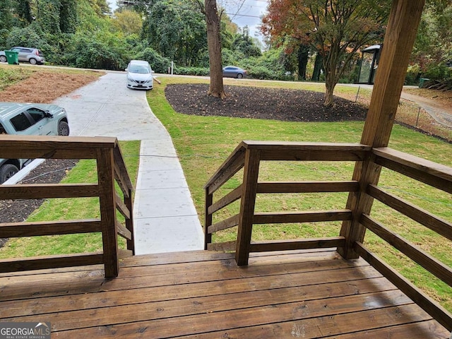 wooden terrace with a yard