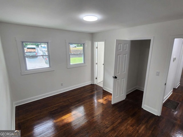 unfurnished bedroom with dark hardwood / wood-style floors