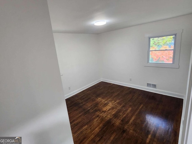 empty room with hardwood / wood-style floors