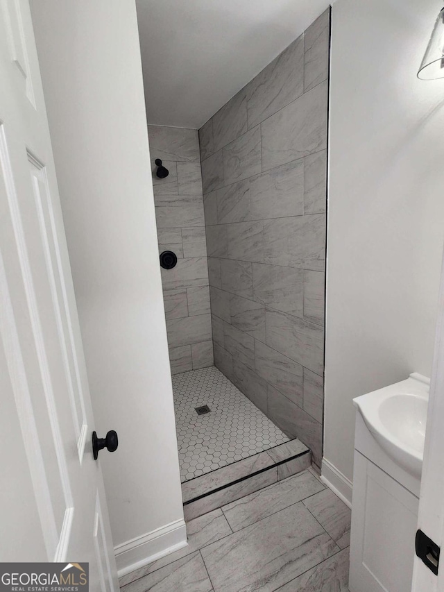 bathroom featuring vanity and tiled shower