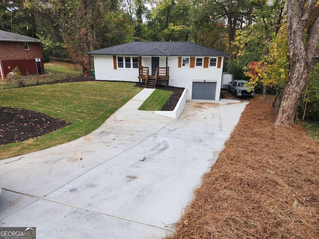 view of front of home with a front yard and a garage