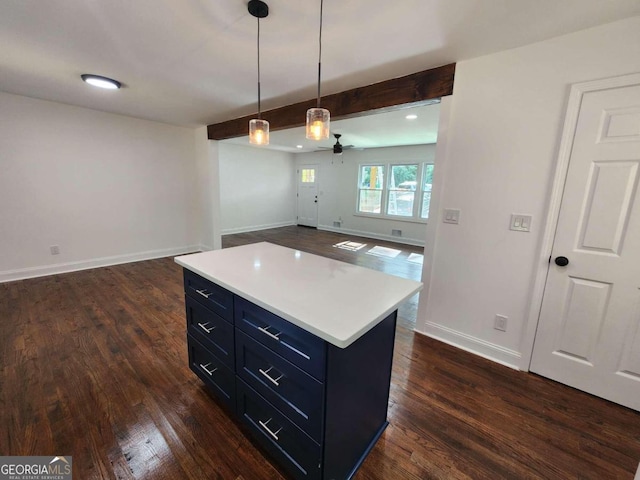 kitchen with dark wood-type flooring, ceiling fan, a center island, and hanging light fixtures