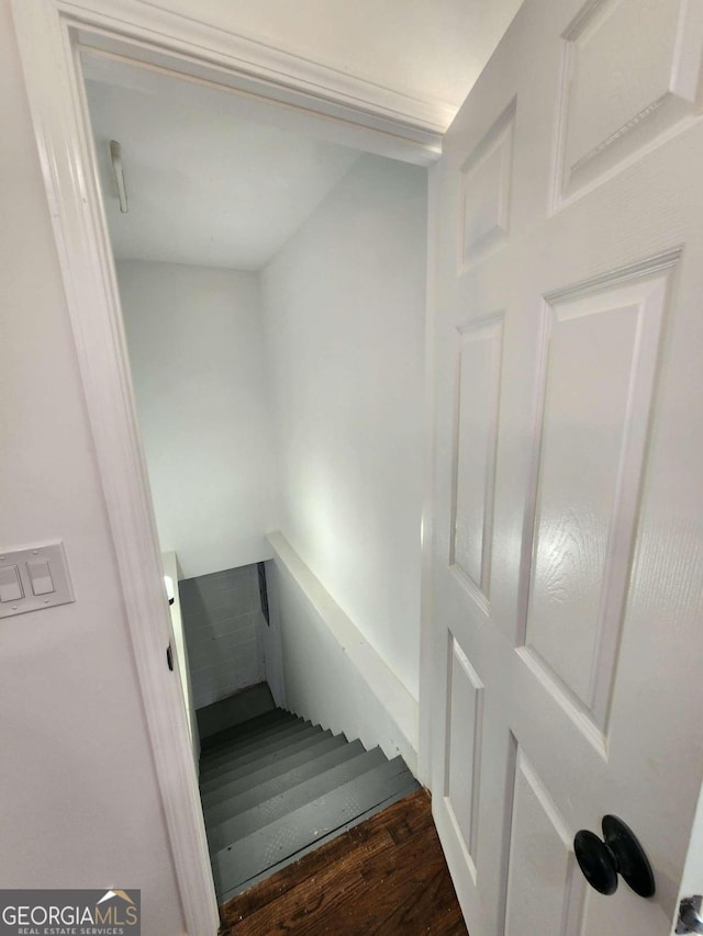 staircase with hardwood / wood-style flooring