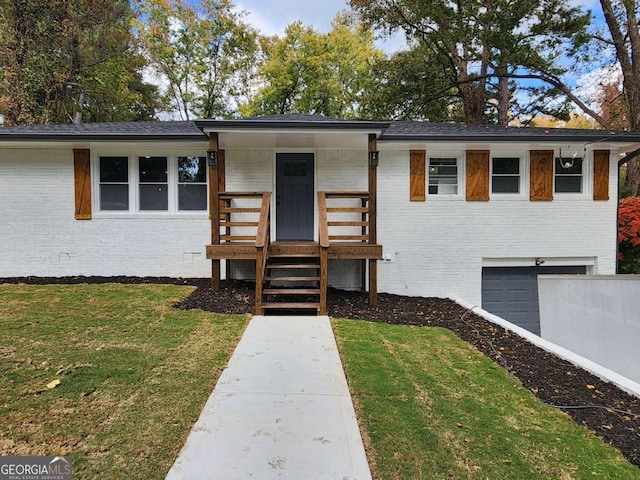 view of front of property with a front yard and a garage