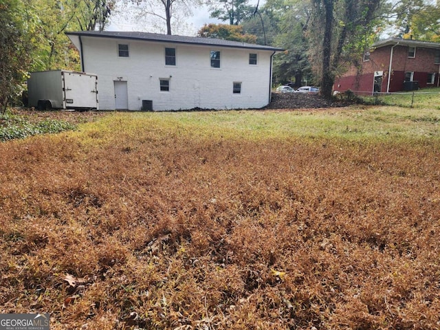 rear view of property with cooling unit