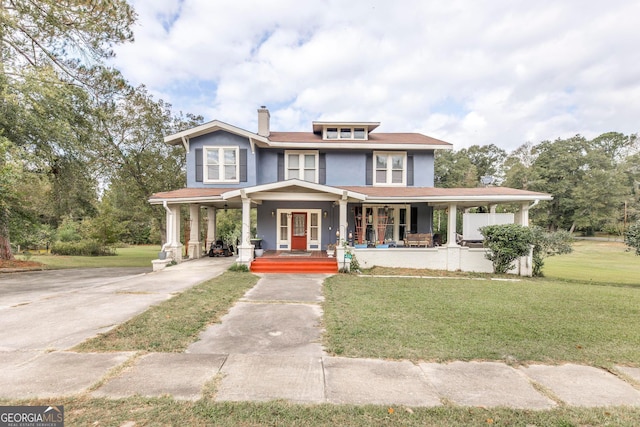 view of front of house with covered porch and a front lawn