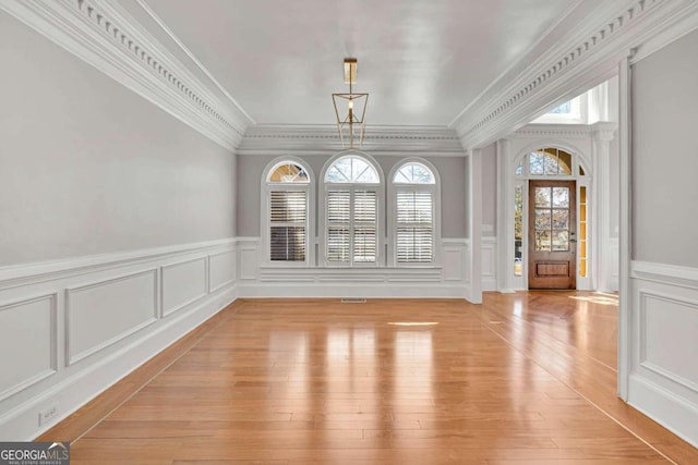 interior space featuring light hardwood / wood-style floors and ornamental molding