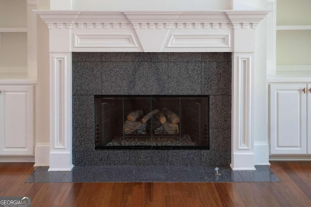 room details with coffered ceiling, wood-type flooring, and a fireplace