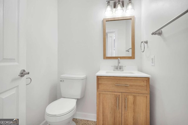 bathroom featuring toilet and vanity