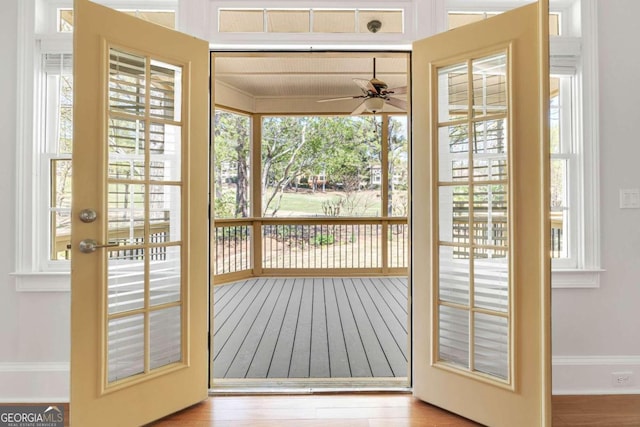 entryway with light hardwood / wood-style floors, a healthy amount of sunlight, and ceiling fan