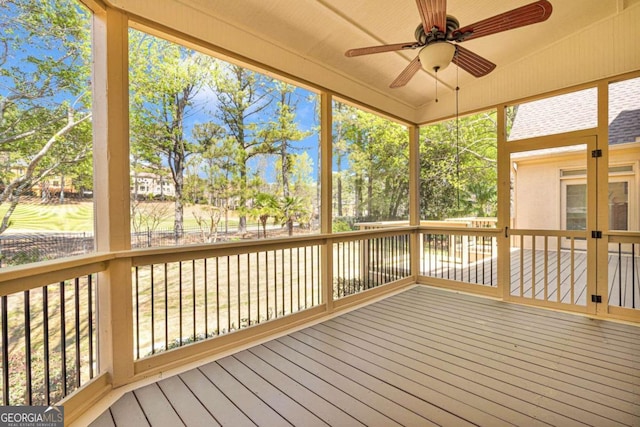 unfurnished sunroom with lofted ceiling and ceiling fan