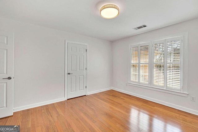 unfurnished room with light hardwood / wood-style flooring