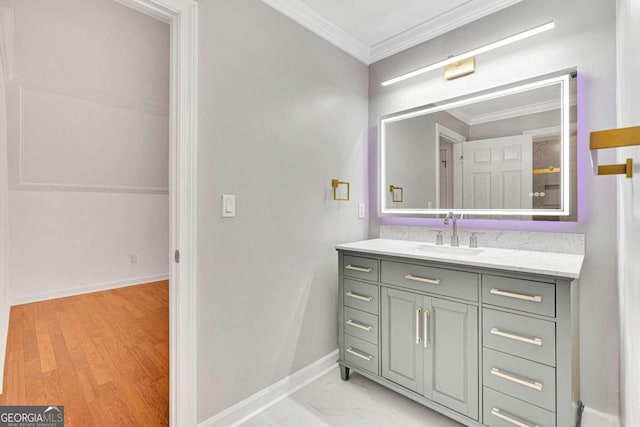 bathroom with vanity, hardwood / wood-style flooring, and ornamental molding