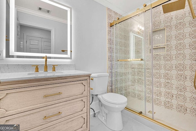 bathroom featuring vanity, crown molding, toilet, and an enclosed shower