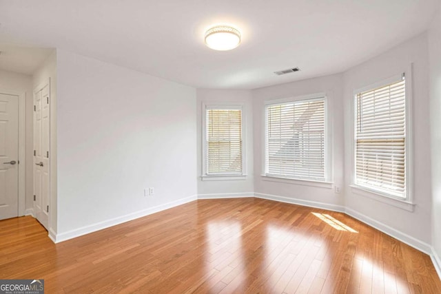 unfurnished room with a wealth of natural light and light wood-type flooring