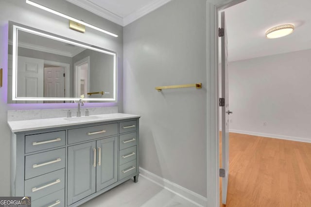 bathroom with vanity, crown molding, and hardwood / wood-style floors