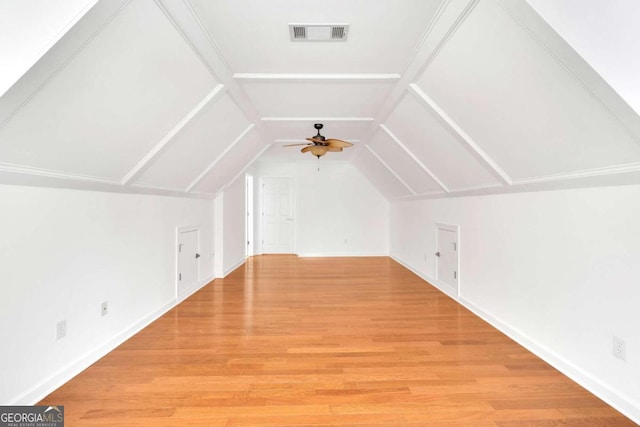 additional living space featuring lofted ceiling, hardwood / wood-style flooring, and ceiling fan