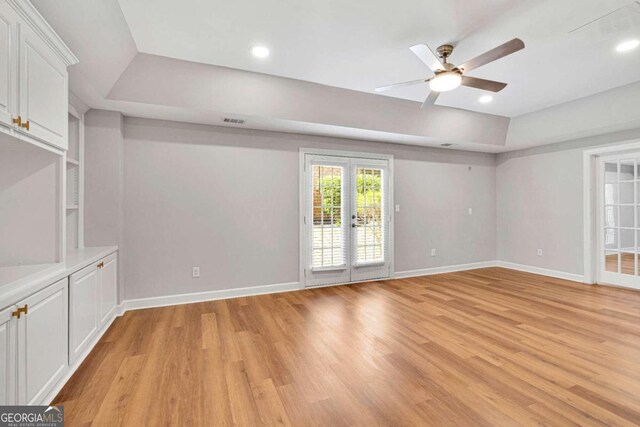 unfurnished room with light hardwood / wood-style floors, french doors, and ceiling fan