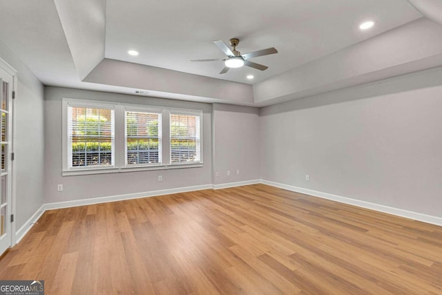 empty room featuring light hardwood / wood-style flooring and ceiling fan