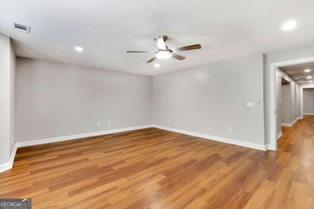 spare room featuring light hardwood / wood-style flooring and ceiling fan