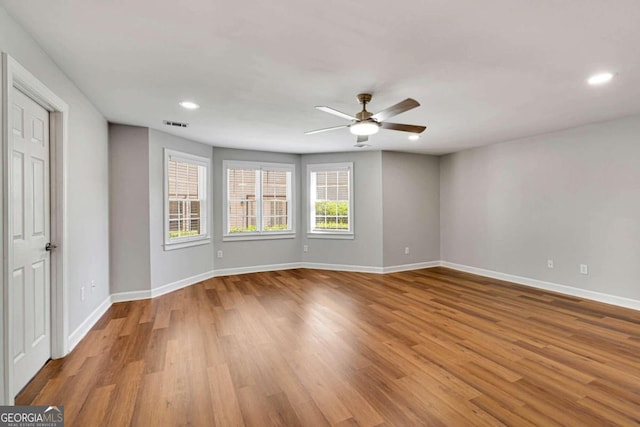 empty room featuring ceiling fan and light hardwood / wood-style flooring