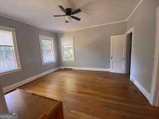 unfurnished room featuring ornamental molding, ceiling fan, and dark hardwood / wood-style flooring