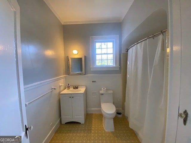 bathroom featuring vanity, crown molding, walk in shower, and toilet