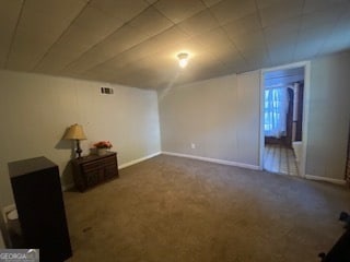 unfurnished room with dark colored carpet