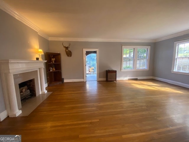 unfurnished living room featuring crown molding and hardwood / wood-style floors