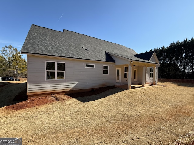 back of property featuring ceiling fan and a patio area