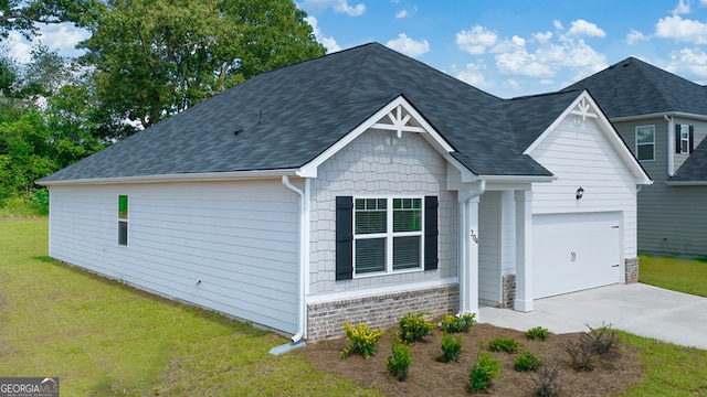 view of front of home with a front lawn and a garage