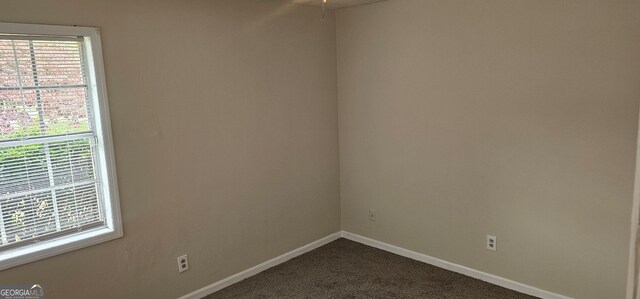 carpeted empty room featuring ceiling fan