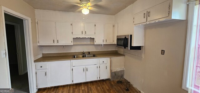 kitchen featuring a wealth of natural light, white cabinetry, and dark hardwood / wood-style flooring