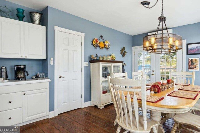 dining room with french doors and a chandelier