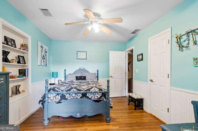 bedroom with ceiling fan and hardwood / wood-style flooring